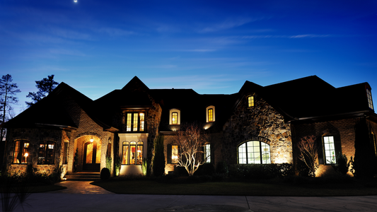 Residential property with layered low-voltage landscape lighting at dusk