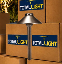 Load image into Gallery viewer, A TotalLight pathlight with a brushed metal dome shade and textured post, standing in front of stacked cardboard boxes with TotalLight branding.
