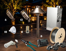 Load image into Gallery viewer, Outdoor landscape lighting kit with multiple components including spotlights, a ground stake lamp, control box, wire spool, connectors, and tools, arranged on a patio at night with warm lights on in the background.
